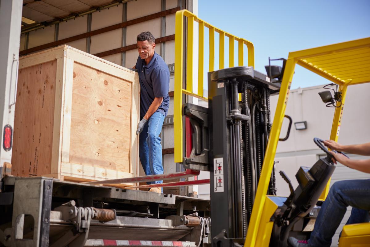 Loading crated business assets for shipping at The Packaging Store in Philadelphia